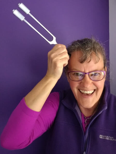 Dianne Ashcroft with a tuning fork held to her head