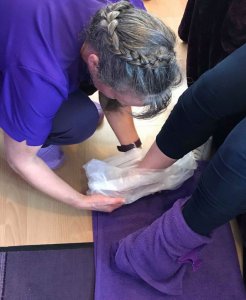 Dianne Ashcroft treating a patient with warm wax therapy