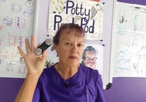 Dianne holding up a portable ECG machine